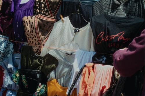 Assorted casual clothes hung on clothing rack